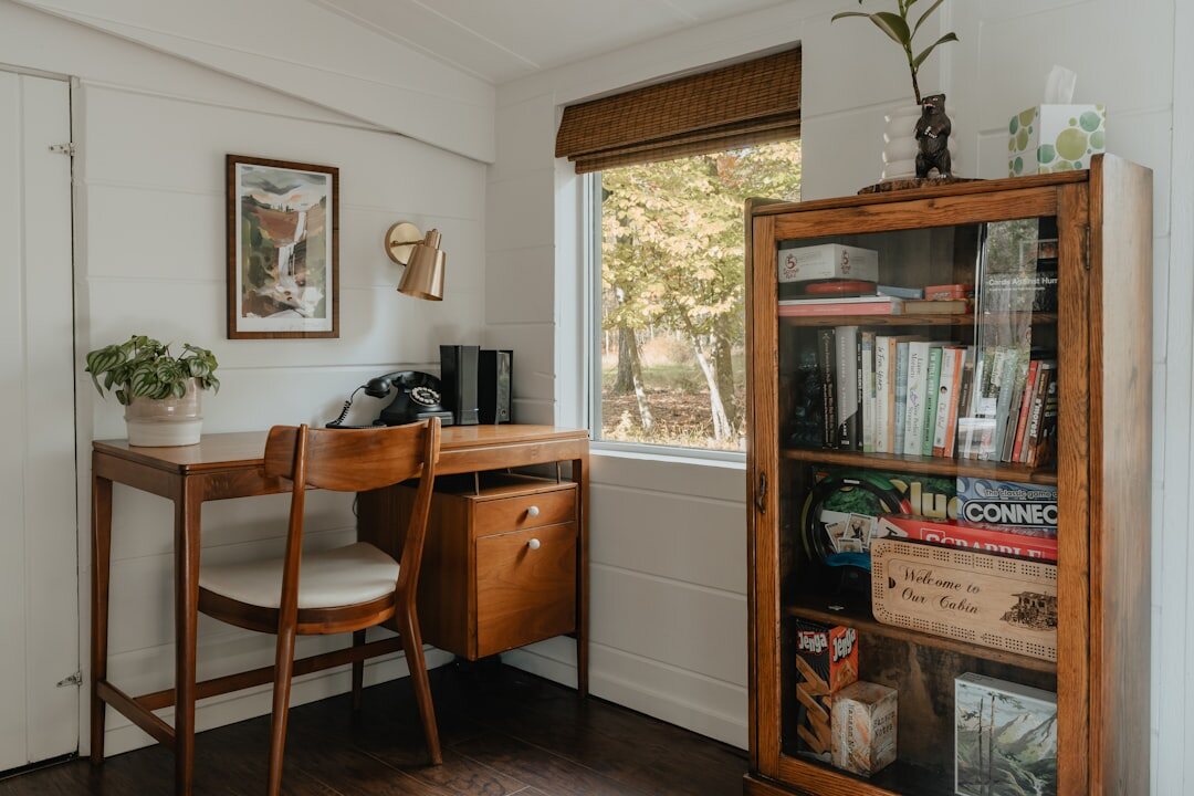 Bright contemporary office corner with plants and bookshelf
